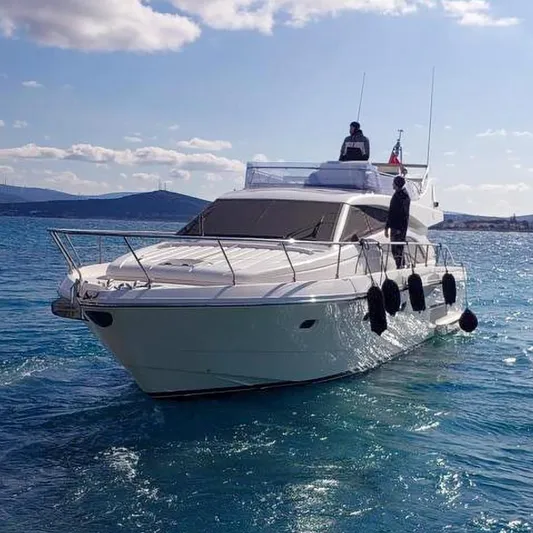  Yacht Photos Pics 2005 Ferretti Yachts 530 cruising on clear blue water under a partly cloudy sky.