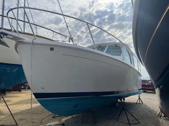  Yacht Photos Pics 2011 Back Cove 30 boat on stands, under a cloudy sky.