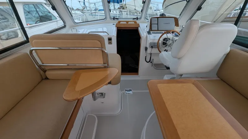  Yacht Photos Pics Interior of 2011 Back Cove 30 boat with beige seating and modern helm.