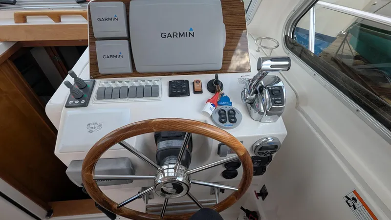  Yacht Photos Pics Helm of 2011 Back Cove 30 boat with Garmin navigation system and wooden steering wheel.