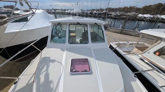  Yacht Photos Pics 2011 Back Cove 30 boat docked at marina, showcasing front deck and cabin windows.