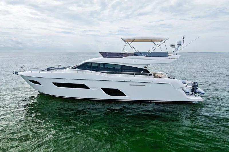 Acqua Yacht Photos Pics 2018 Ferretti Yachts 550 cruising on calm waters under a cloudy sky.