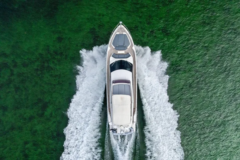 Acqua Yacht Photos Pics Aerial view of 2018 Ferretti Yachts 550 cruising on green water.