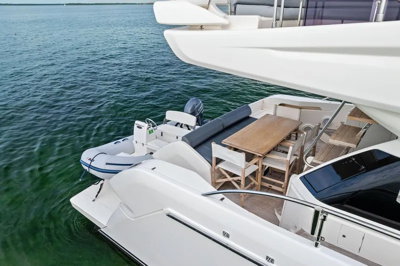 Acqua Yacht Photos Pics 2018 Ferretti Yachts 550 with outdoor dining area and tender on calm water.