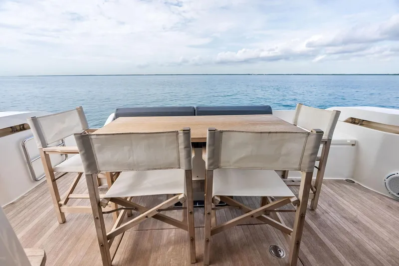 Acqua Yacht Photos Pics Outdoor dining area on 2018 Ferretti Yachts 550, overlooking serene ocean view.