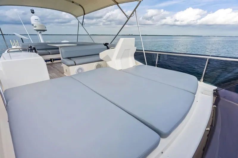 Acqua Yacht Photos Pics 2018 Ferretti Yachts 550 flybridge with cushioned seating, overlooking serene ocean view.
