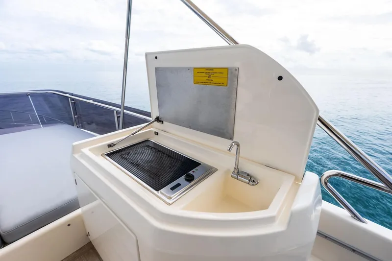 Acqua Yacht Photos Pics Outdoor kitchenette on 2018 Ferretti Yachts 550, featuring a grill and sink.