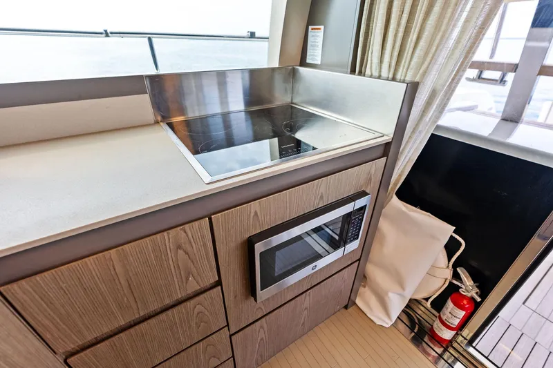 Acqua Yacht Photos Pics Modern kitchen area on 2018 Ferretti Yachts 550 with stove and microwave.