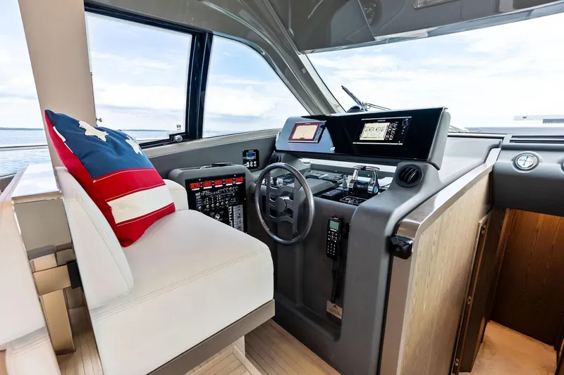 Acqua Yacht Photos Pics 2018 Ferretti Yachts 550 helm with modern controls and American flag pillow.