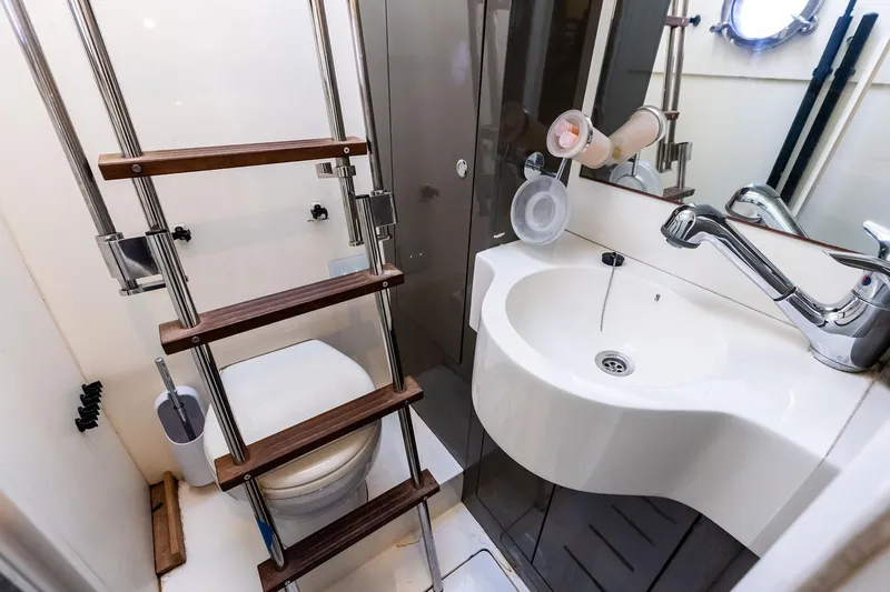 Acqua Yacht Photos Pics Bathroom interior of 2018 Ferretti Yachts 550, featuring compact sink and ladder.