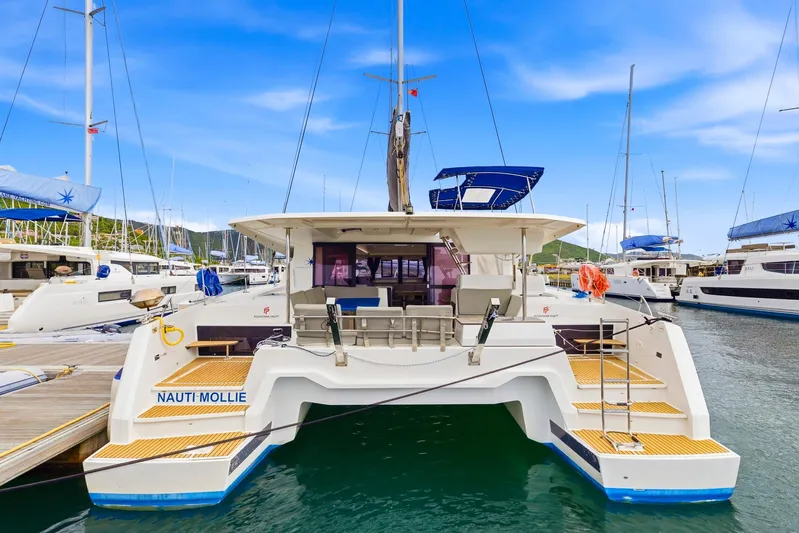 Nauti Mollie Yacht Photos Pics 2020 Fountaine Pajot Astrea 42 Catamaran docked in a marina, rear view.