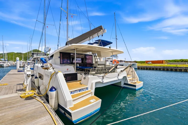 Nauti Mollie Yacht Photos Pics 2020 Fountaine Pajot Astrea 42 Catamaran docked at marina under clear blue sky.