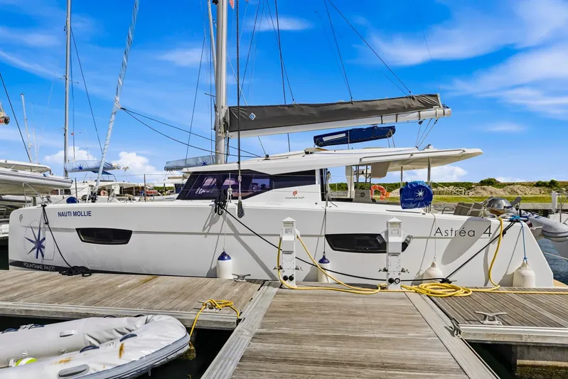 Nauti Mollie Yacht Photos Pics 2020 Fountaine Pajot Astrea 42 Catamaran docked at marina under blue sky.