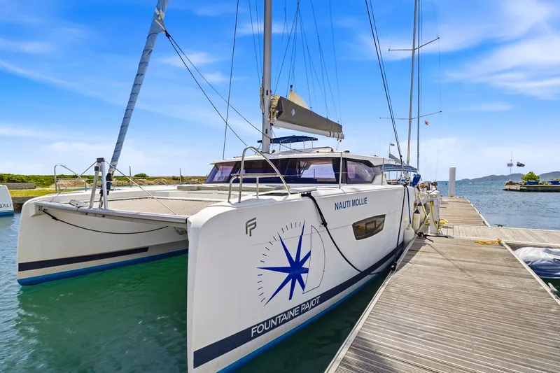 Nauti Mollie Yacht Photos Pics 2020 Fountaine Pajot Astrea 42 Catamaran docked at marina under clear blue sky.
