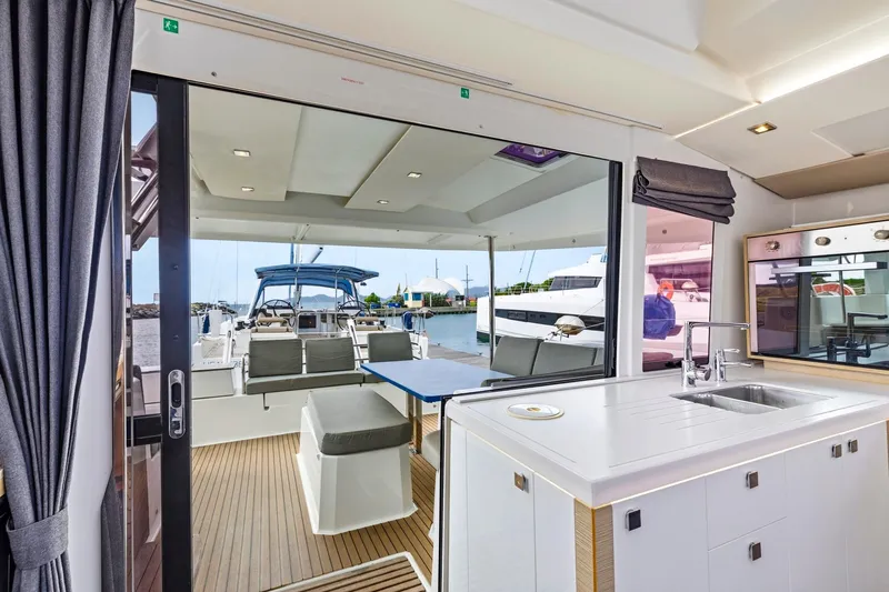 Nauti Mollie Yacht Photos Pics Interior view of 2020 Fountaine Pajot Astrea 42 Catamaran, featuring modern kitchen and outdoor seating.