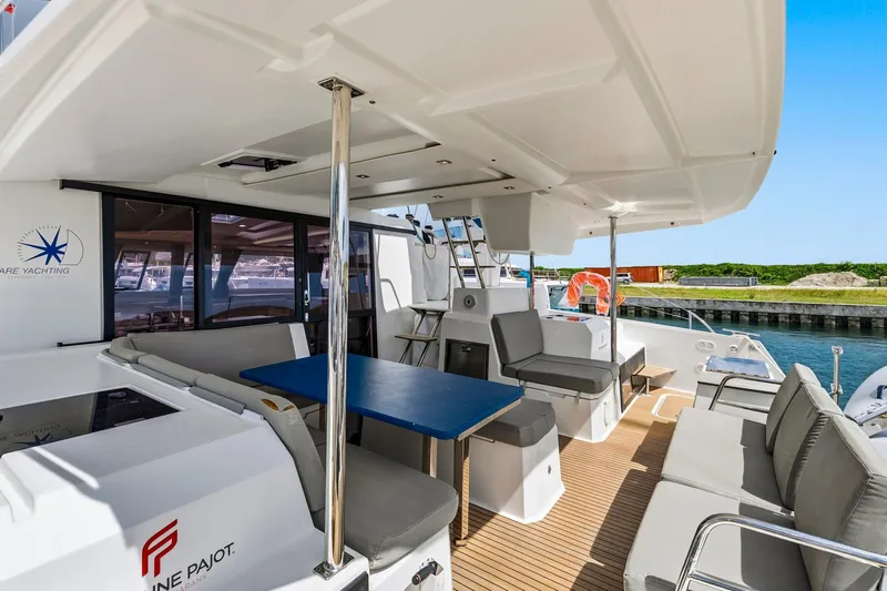 Nauti Mollie Yacht Photos Pics 2020 Fountaine Pajot Astrea 42 Catamaran, spacious deck with seating and dining area.