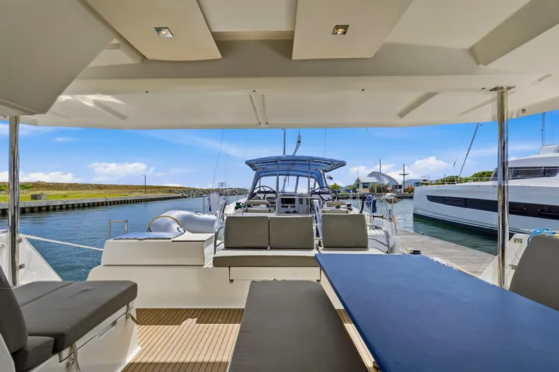 Nauti Mollie Yacht Photos Pics 2020 Fountaine Pajot Astrea 42 Catamaran interior, docked with scenic marina view.