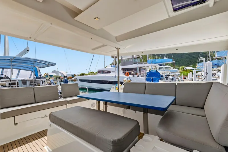 Nauti Mollie Yacht Photos Pics 2020 Fountaine Pajot Astrea 42 Catamaran interior with seating and table in marina.