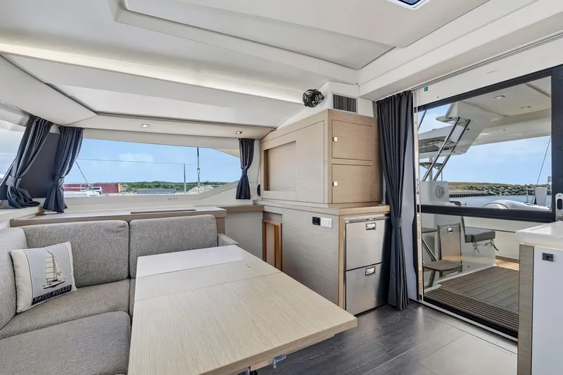 Nauti Mollie Yacht Photos Pics Luxurious interior of 2020 Fountaine Pajot Astrea 42 Catamaran with modern furnishings and scenic views.