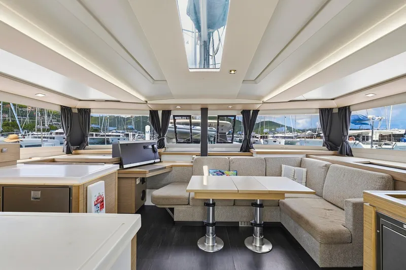 Nauti Mollie Yacht Photos Pics Luxurious interior of 2020 Fountaine Pajot Astrea 42 Catamaran with modern seating and panoramic windows.