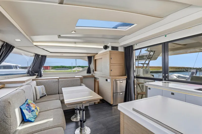 Nauti Mollie Yacht Photos Pics Luxurious interior of 2020 Fountaine Pajot Astrea 42 Catamaran with modern furnishings and panoramic windows.