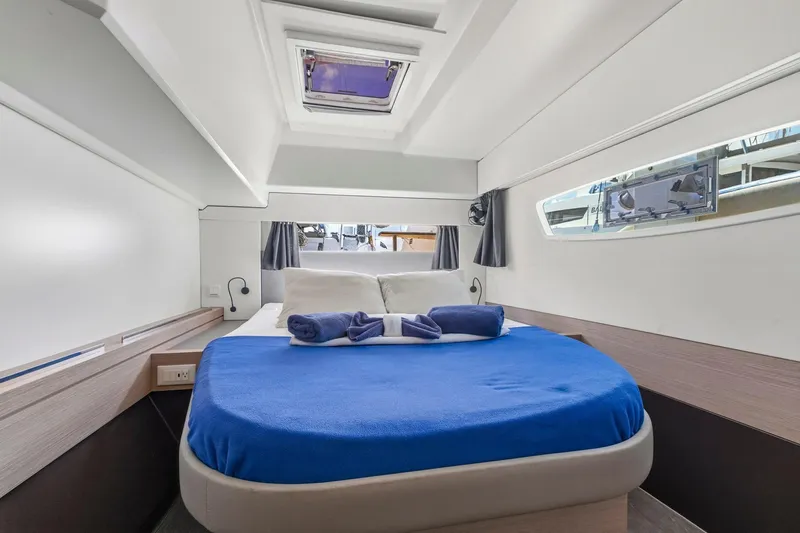 Nauti Mollie Yacht Photos Pics Luxurious cabin interior of 2020 Fountaine Pajot Astrea 42 Catamaran with blue bedding.