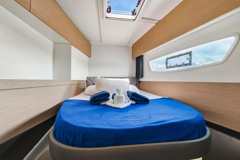 Nauti Mollie Yacht Photos Pics Luxurious cabin interior of 2020 Fountaine Pajot Astrea 42 Catamaran with blue bedding.