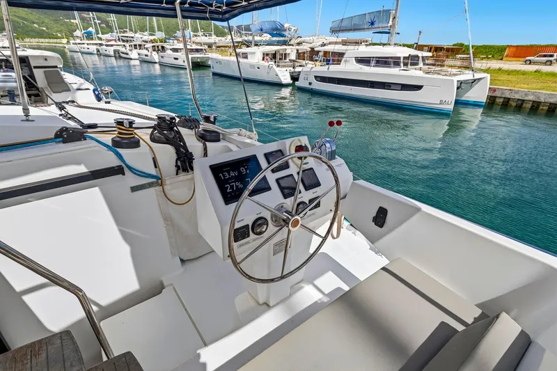 Nauti Mollie Yacht Photos Pics 2020 Fountaine Pajot Astrea 42 Catamaran helm with marina view.