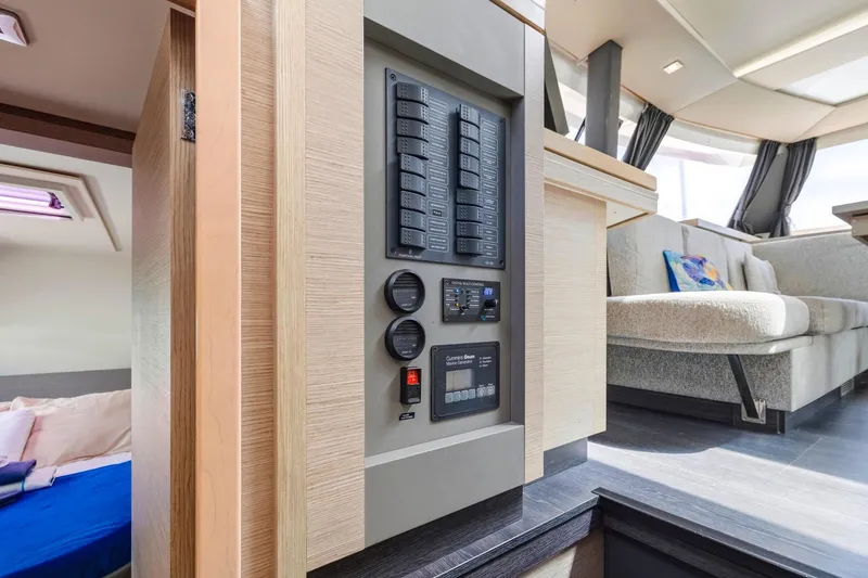 Nauti Mollie Yacht Photos Pics Interior of 2020 Fountaine Pajot Astrea 42 Catamaran with control panel and seating area.