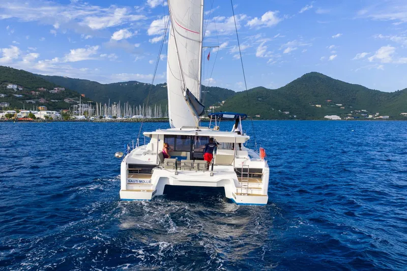 Nauti Mollie Yacht Photos Pics 2020 Fountaine Pajot Astrea 42 Catamaran sailing in scenic coastal waters.