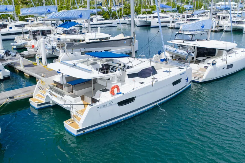 Nauti Mollie Yacht Photos Pics 2020 Fountaine Pajot Astrea 42 Catamaran docked in a marina, surrounded by other boats.