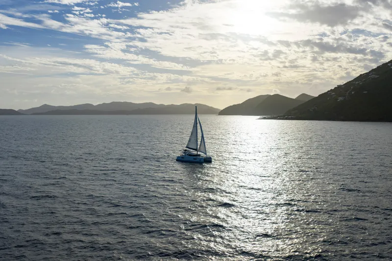 Nauti Mollie Yacht Photos Pics 2020 Fountaine Pajot Astrea 42 Catamaran sailing at sunset on open sea.