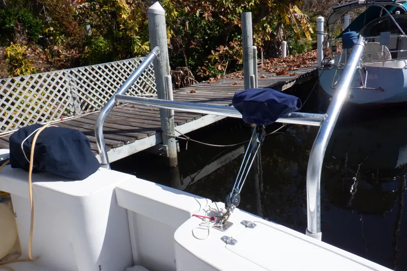 Seaglass Yacht Photos Pics 1999 Mainship 350 Trawler docked, featuring deck equipment and nearby wooden pier.