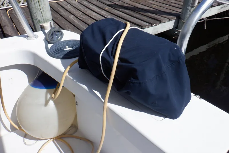 Seaglass Yacht Photos Pics 1999 Mainship 350 Trawler deck with rope, fender, and covered equipment.