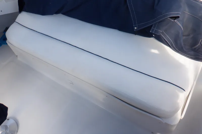 Seaglass Yacht Photos Pics White cushioned seat on 1999 Mainship 350 Trawler boat deck.