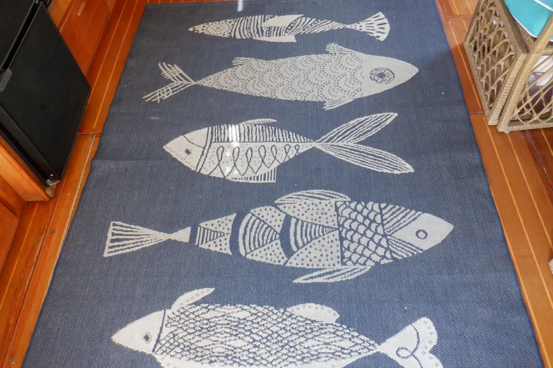 Seaglass Yacht Photos Pics Decorative fish-patterned rug on a 1999 Mainship 350 Trawler boat floor.