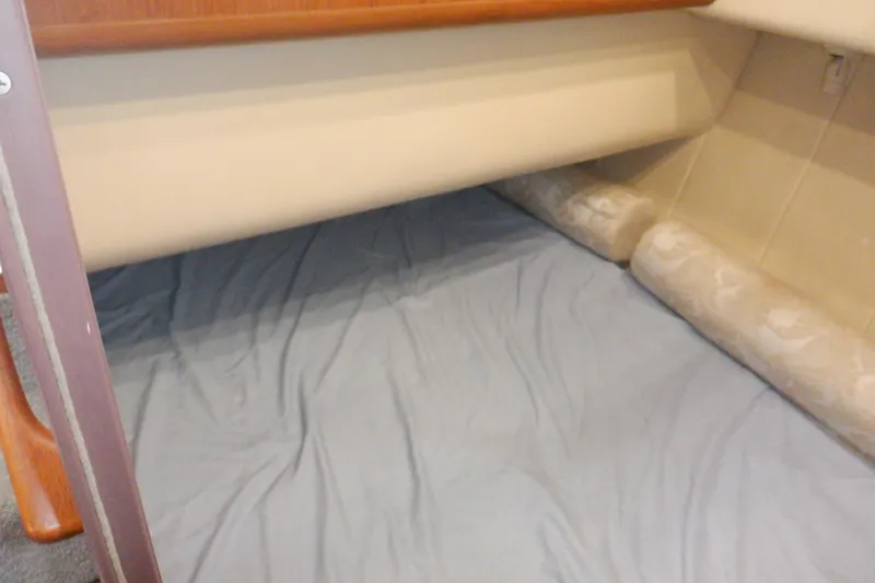 Seaglass Yacht Photos Pics Interior cabin view of a 1999 Mainship 350 Trawler with bedding.