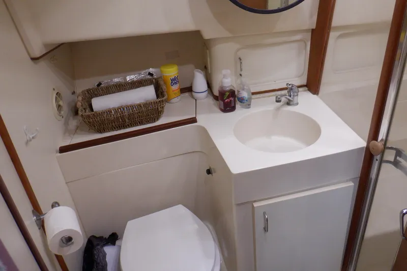 Seaglass Yacht Photos Pics Bathroom interior of 1999 Mainship 350 Trawler with sink, toilet, and toiletries.