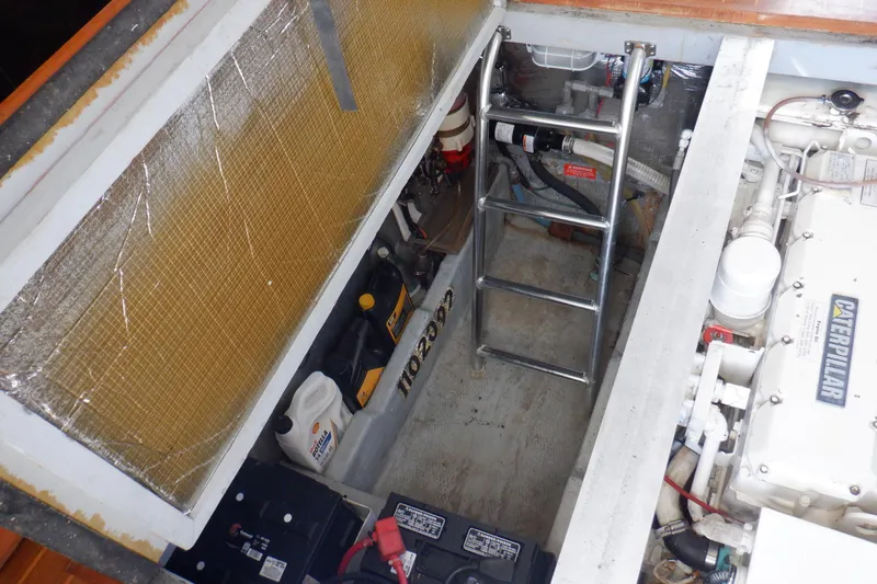 Seaglass Yacht Photos Pics Engine room of 1999 Mainship 350 Trawler with visible ladder and equipment.