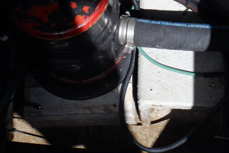 Seaglass Yacht Photos Pics Engine compartment of a 1999 Mainship 350 Trawler with exhaust hose and clamps.
