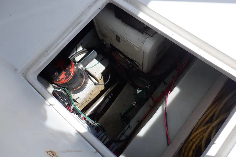 Seaglass Yacht Photos Pics Engine compartment of a 1999 Mainship 350 Trawler, showing mechanical components and wiring.