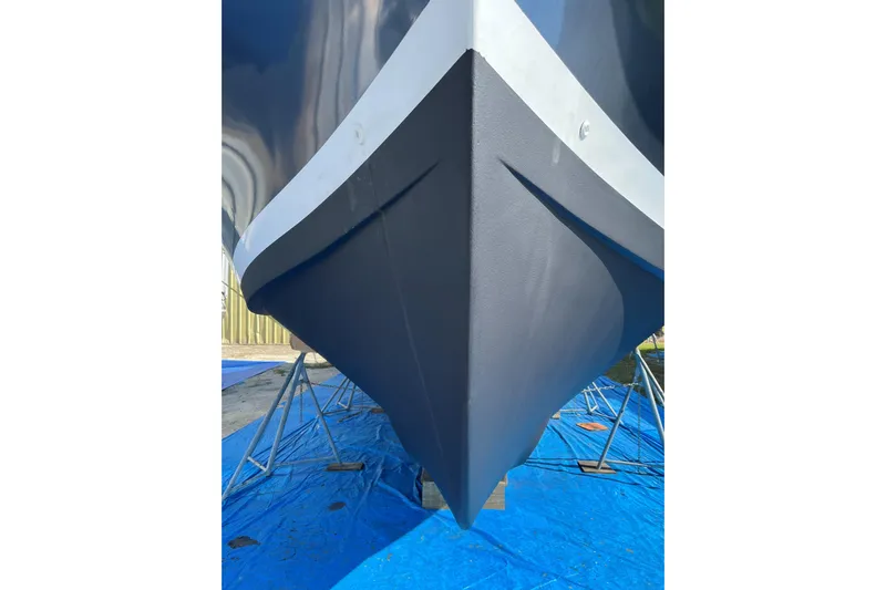 Seaglass Yacht Photos Pics 1999 Mainship 350 Trawler bow on blue tarp, supported by stands.