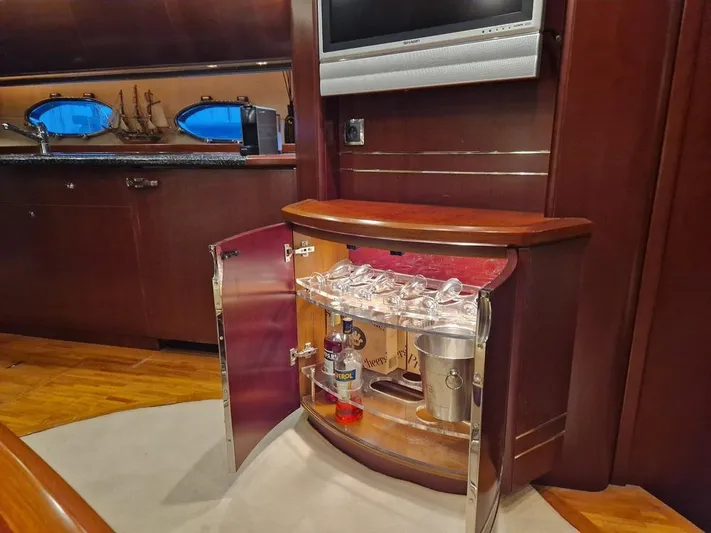  Yacht Photos Pics Luxurious yacht interior with a minibar cabinet, glassware, and liquor bottles, Princess V58 2006 model.
