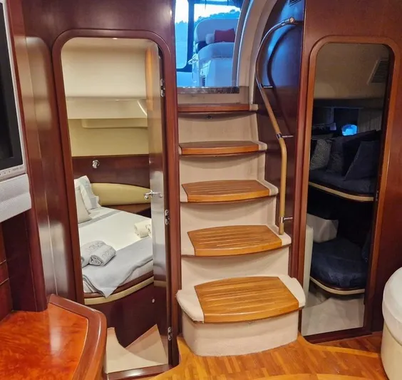  Yacht Photos Pics Luxurious interior of 2006 Princess V58 yacht with wooden stairs and cozy cabins.