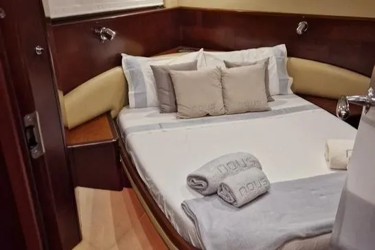  Yacht Photos Pics Luxurious cabin interior of 2006 Princess V58 yacht with cozy bed and elegant decor.