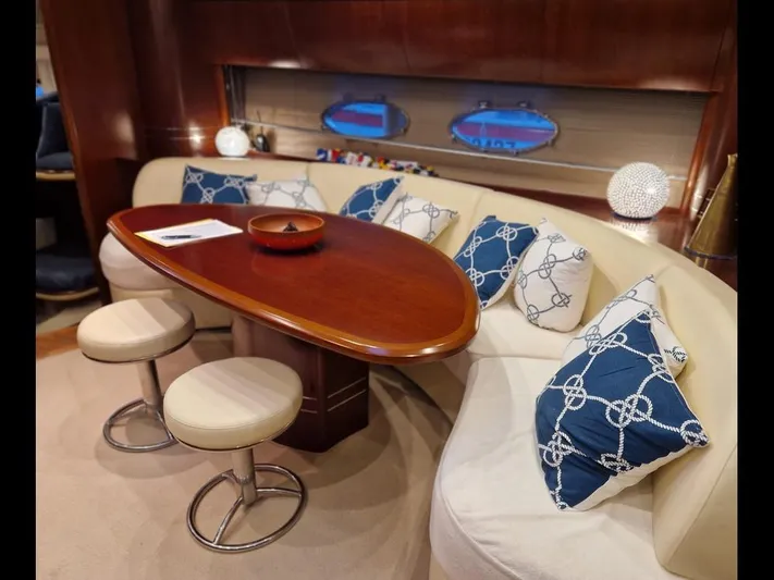  Yacht Photos Pics Luxurious interior of 2006 Princess V58 yacht with elegant seating and nautical-themed cushions.