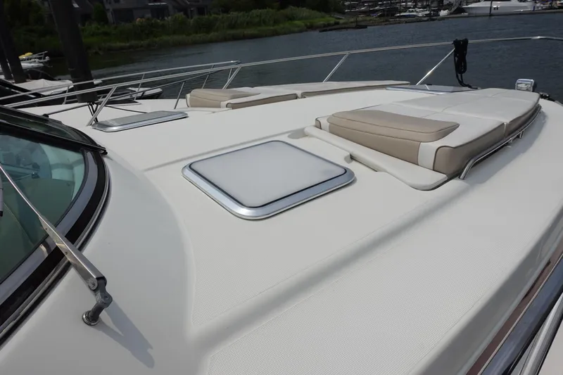  Yacht Photos Pics 2016 Formula 34 Cruiser yacht deck with sun pads and hatch, docked by the water.