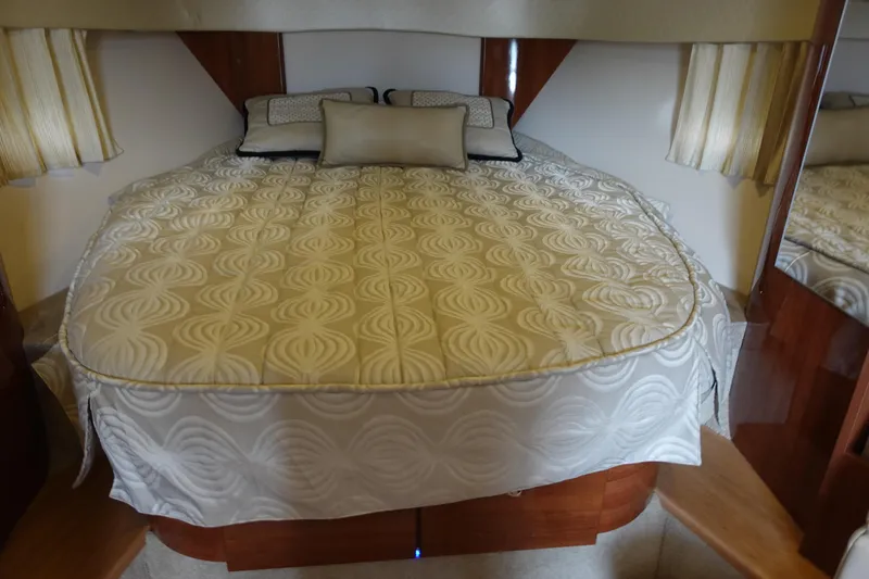  Yacht Photos Pics Luxurious bedroom interior of 2016 Formula 34 Cruiser with elegant bedding and wood accents.