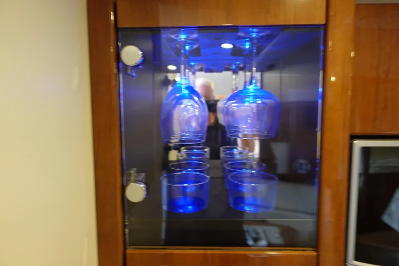  Yacht Photos Pics Glass cabinet with blue-lit glasses in a 2016 Formula 34 Cruiser yacht interior.