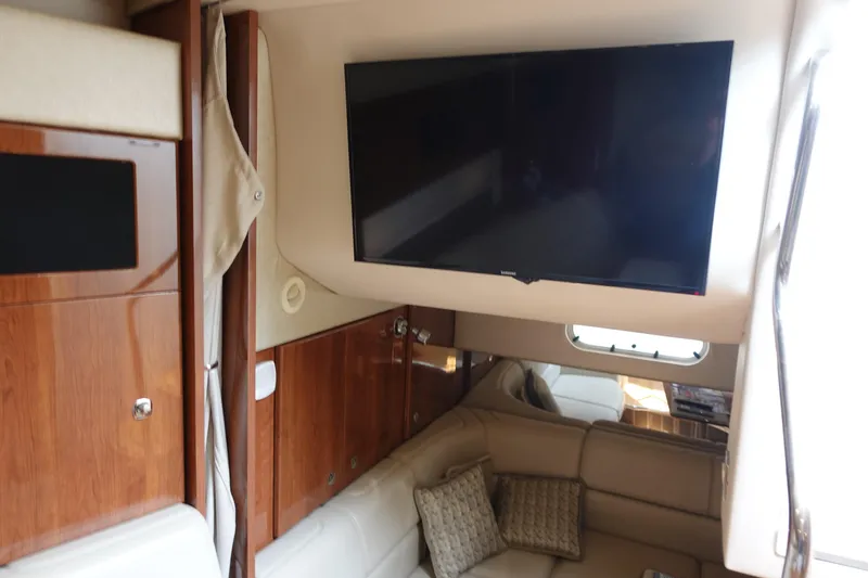  Yacht Photos Pics Interior of 2016 Formula 34 Cruiser with TV, wood cabinets, and beige seating.